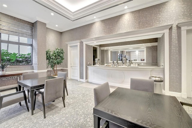 dining space featuring ornamental molding and light carpet