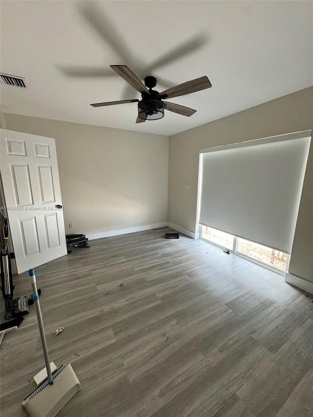 unfurnished bedroom featuring dark hardwood / wood-style flooring and ceiling fan