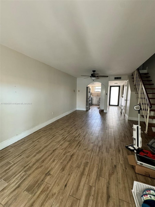 unfurnished living room with ceiling fan and hardwood / wood-style flooring