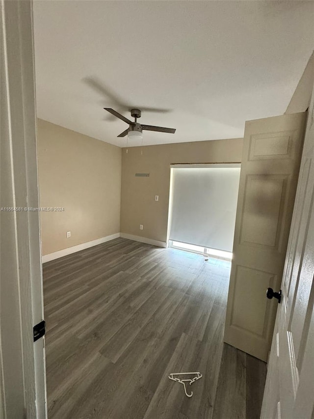 unfurnished room with ceiling fan and dark hardwood / wood-style floors