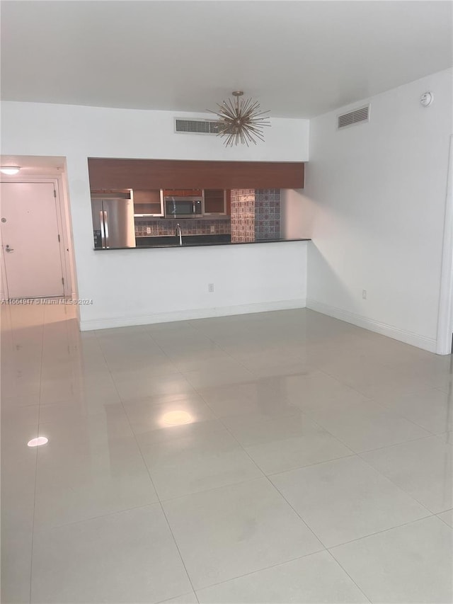 spare room with light tile patterned floors