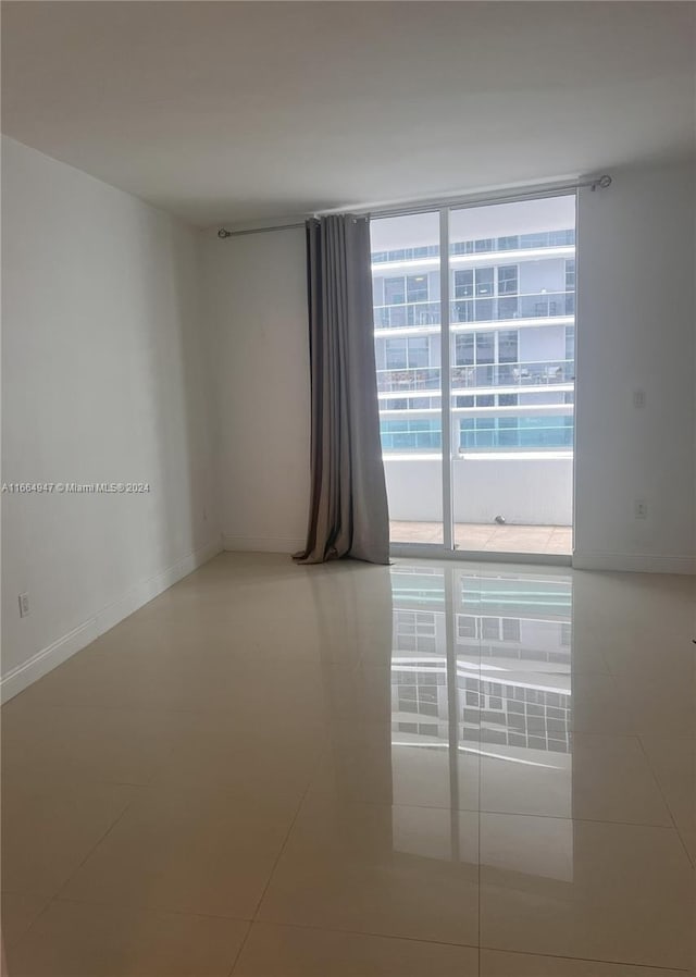 unfurnished room featuring tile patterned flooring