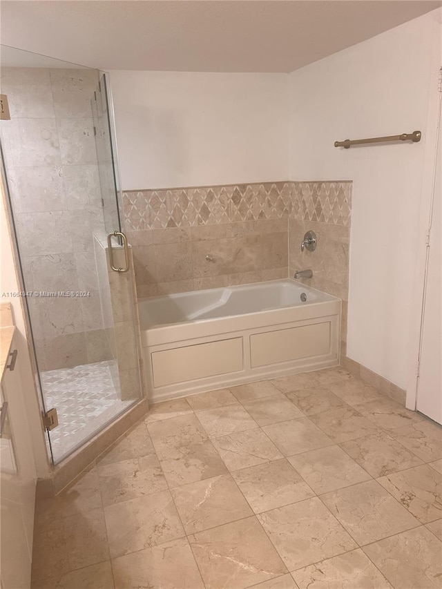 bathroom with vanity and separate shower and tub