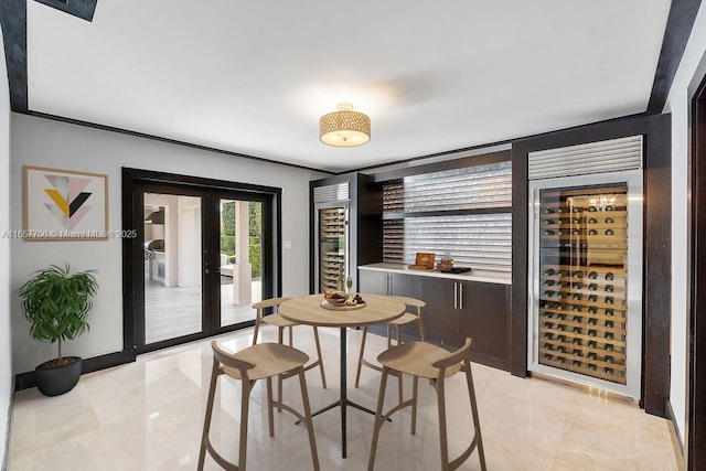 dining space featuring french doors and beverage cooler