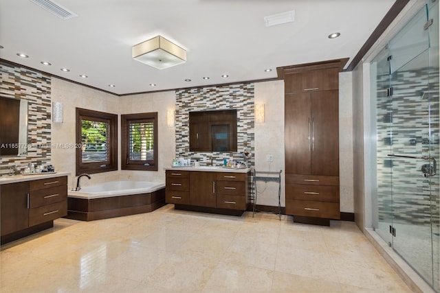 full bath with a garden tub, two vanities, visible vents, tile walls, and a shower stall