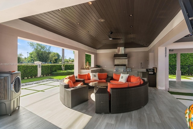 view of patio / terrace featuring exterior kitchen, outdoor lounge area, ceiling fan, and a sink