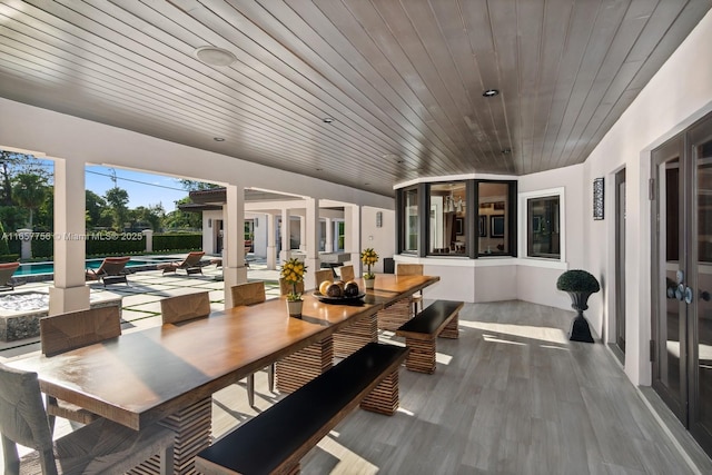 view of patio with fence, outdoor dining area, and a fenced in pool