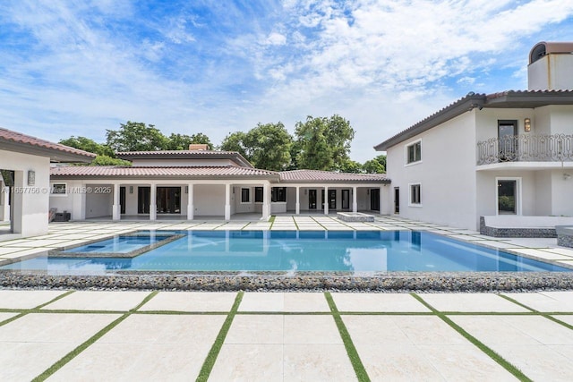 view of pool with a pool with connected hot tub and a patio