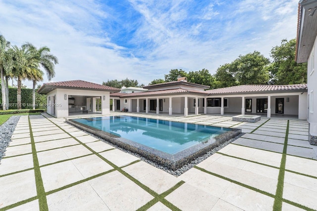 outdoor pool featuring a storage structure and a patio