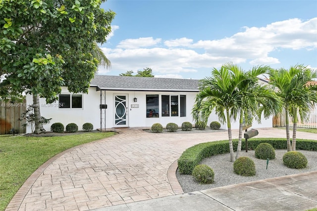 ranch-style home featuring a front yard