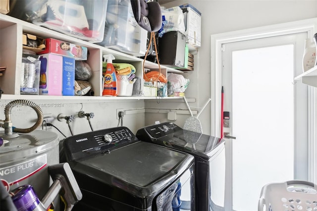 clothes washing area with water heater and washing machine and dryer