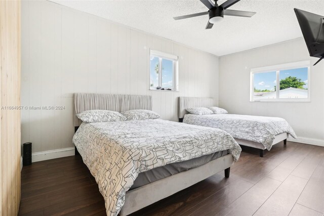 bedroom with multiple windows, hardwood / wood-style flooring, and ceiling fan