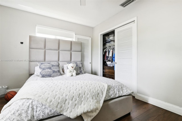 bedroom with dark wood-type flooring and a closet