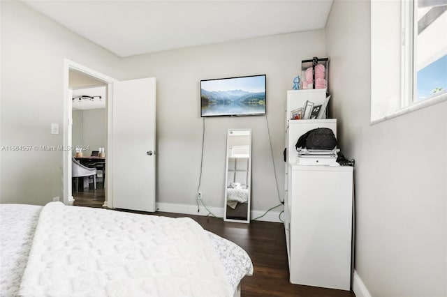 bedroom with dark hardwood / wood-style floors