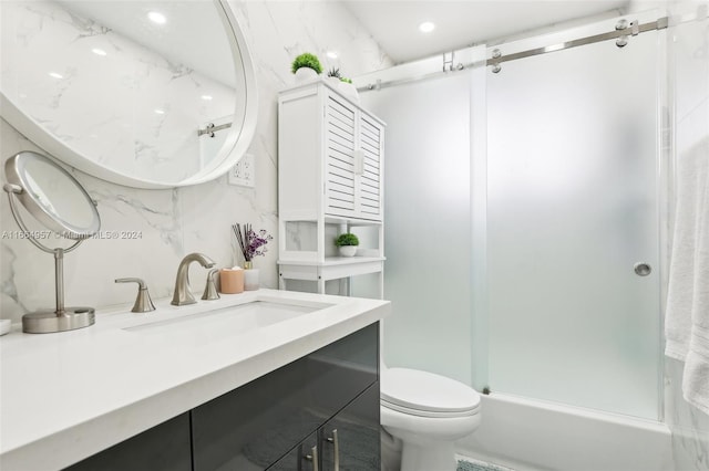 full bathroom with shower / bath combination with glass door, vanity, and toilet