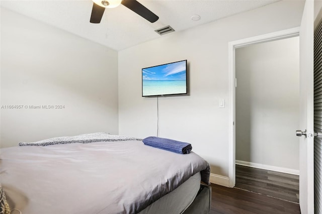 bedroom featuring a textured ceiling, dark wood-type flooring, and ceiling fan