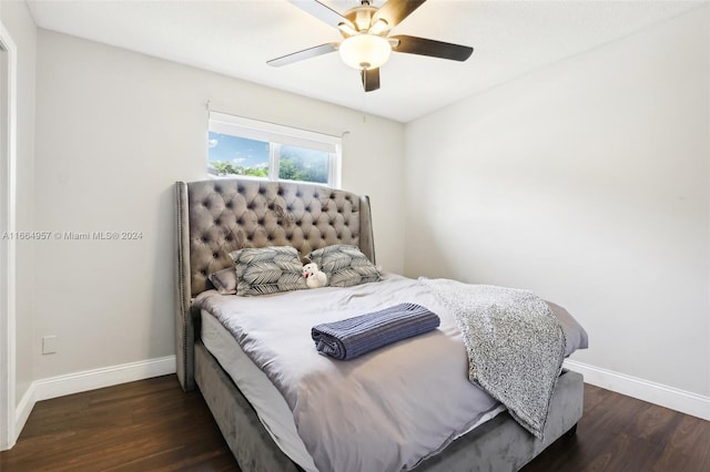 bedroom with dark hardwood / wood-style flooring and ceiling fan