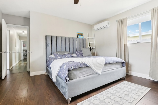 bedroom with ceiling fan, dark hardwood / wood-style flooring, and a wall mounted AC