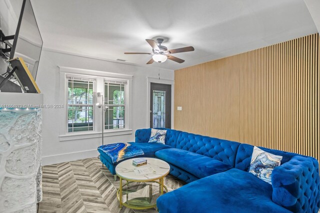 living room featuring ceiling fan and parquet flooring