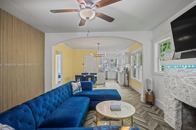 living room with ceiling fan with notable chandelier and light parquet flooring