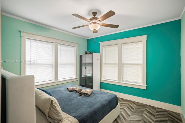 bedroom with ceiling fan, parquet flooring, and crown molding