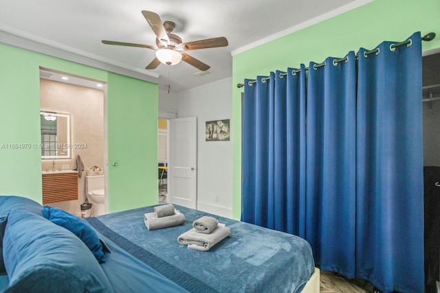 bedroom with ceiling fan, connected bathroom, and crown molding