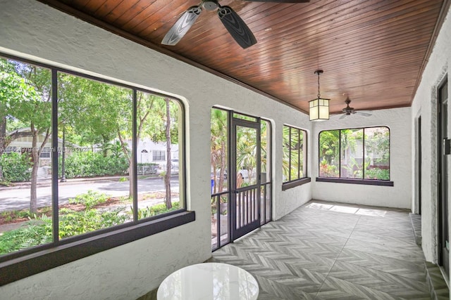 sunroom / solarium with ceiling fan and wood ceiling