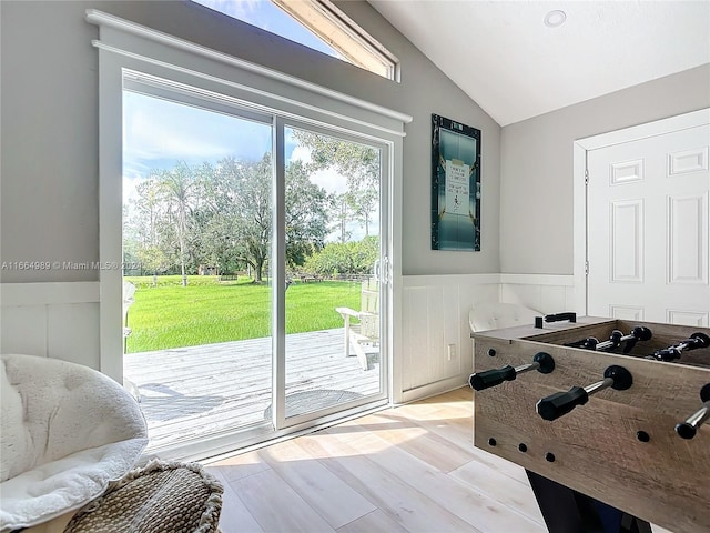 playroom featuring light hardwood / wood-style flooring and lofted ceiling