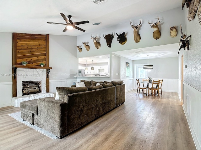 living room with ceiling fan and light hardwood / wood-style flooring