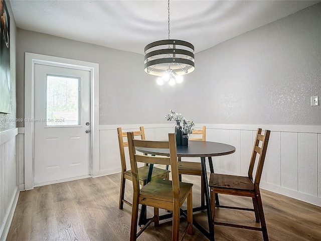 dining area featuring an inviting chandelier and hardwood / wood-style flooring