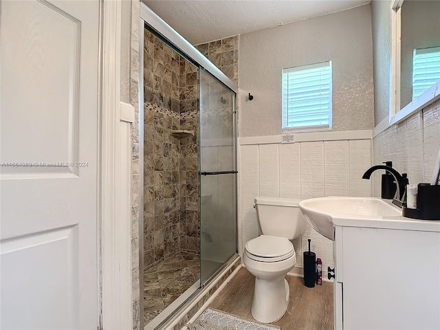 bathroom featuring vanity, hardwood / wood-style floors, a healthy amount of sunlight, and toilet