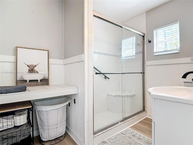 bathroom featuring vanity, an enclosed shower, and hardwood / wood-style flooring