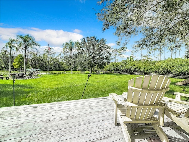 wooden deck featuring a lawn