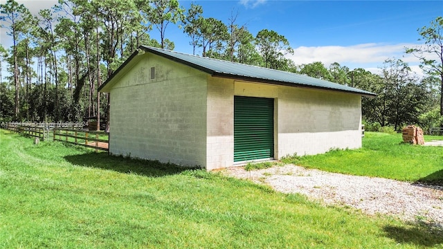 view of outbuilding featuring a lawn