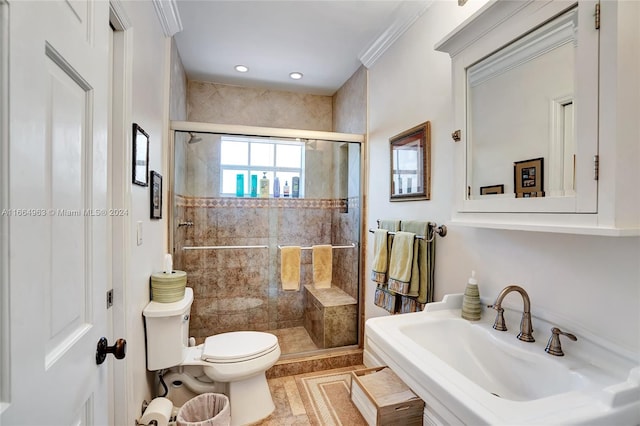 bathroom with ornamental molding, sink, toilet, and an enclosed shower