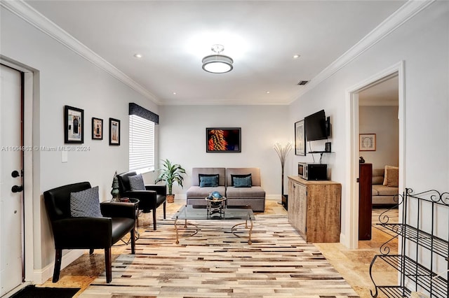 living room with crown molding and light hardwood / wood-style flooring