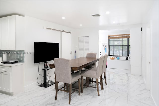 dining space featuring a barn door