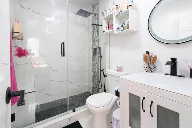 bathroom with an enclosed shower, vanity, and toilet