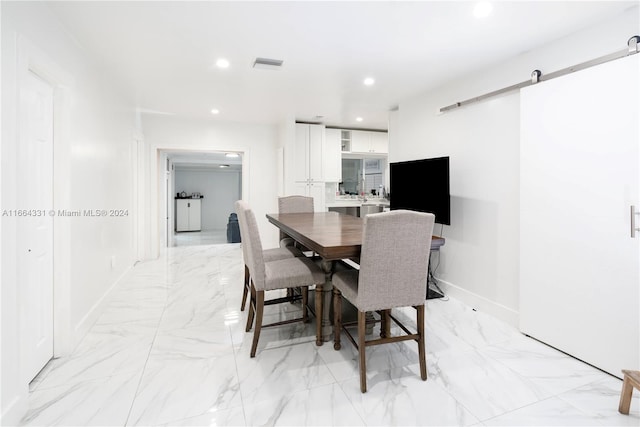 dining space featuring a barn door