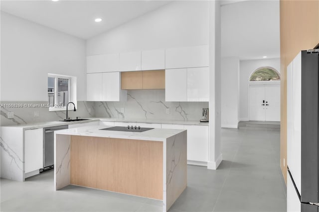 kitchen with white cabinetry, tasteful backsplash, a center island, black electric stovetop, and stainless steel dishwasher