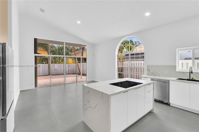 kitchen featuring white cabinets, dishwasher, a center island, and a healthy amount of sunlight