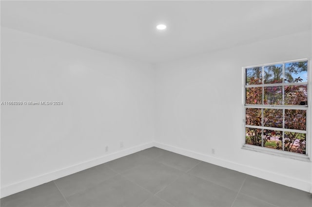 tiled spare room with plenty of natural light