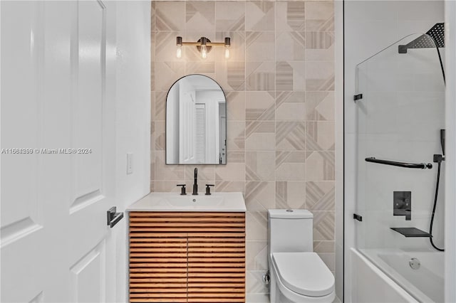 full bathroom with shower / tub combination, tile walls, vanity, and toilet