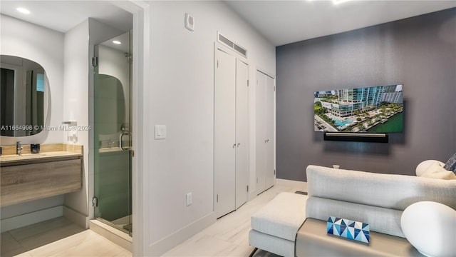 interior space featuring vanity and a shower with shower door