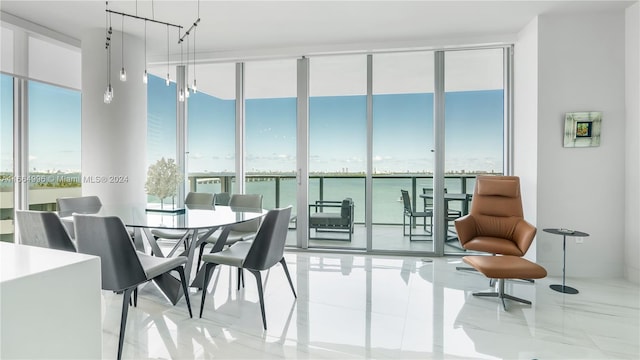 dining room with a wall of windows and a water view