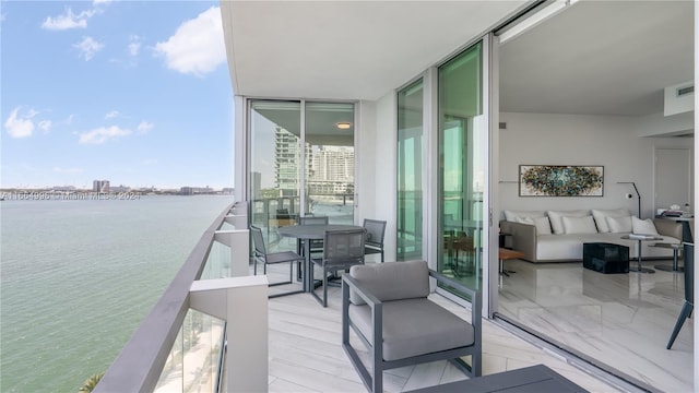 balcony featuring a water view and an outdoor hangout area