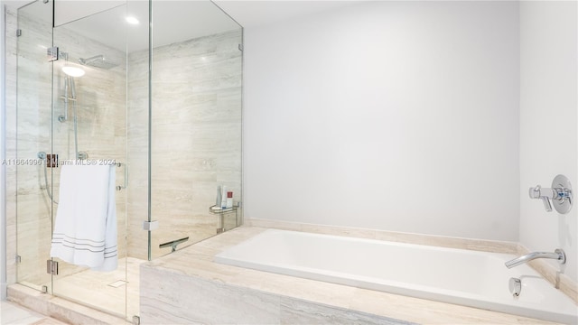 bathroom with shower with separate bathtub