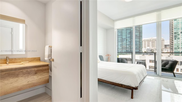 bedroom featuring hardwood / wood-style floors and sink