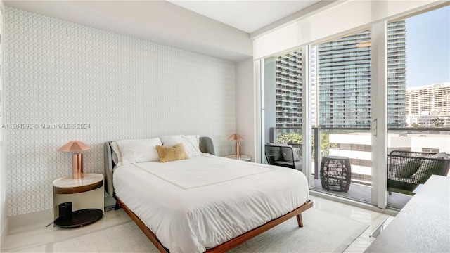 bedroom featuring multiple windows and access to exterior