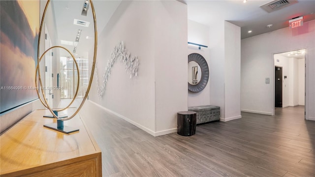 foyer entrance featuring elevator and hardwood / wood-style floors